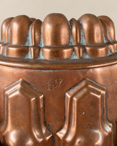 Top view of a French late nineteenth-century copper jelly mould has a finely articulated oval form. Stepped Gothic arches encircle the body beneath a crown of eight rounded lobes.