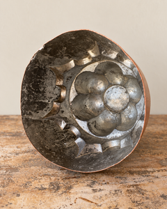 A striking nineteenth-century French copper jelly mould with a tall, tiered silhouette, rounded upper lobes and an architectural scalloped base.