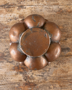 A nineteenth-century French copper jelly mould with a tall, tiered silhouette, rounded upper lobes and an architectural scalloped base.