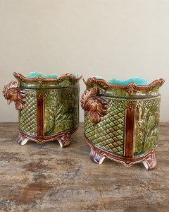 Pair of antique majolica cachepots with rooster-head handles, green and brown glaze and duck egg blue interiors.