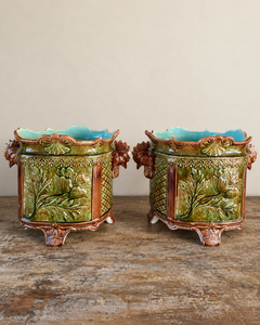 Pair of antique majolica cachepots with rooster-head handles, green and brown glaze and duck egg blue interiors.