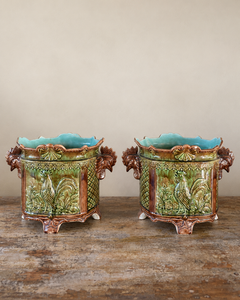 Pair of antique majolica cachepots with rooster-head handles, green and brown glaze and duck egg blue interiors.