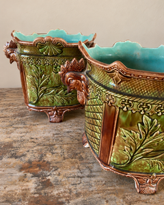 Pair of antique majolica cachepots with rooster-head handles, green and brown glaze and duck egg blue interiors.