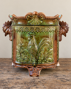 Pair of antique majolica cachepots with rooster-head handles, green and brown glaze and duck egg blue interiors.