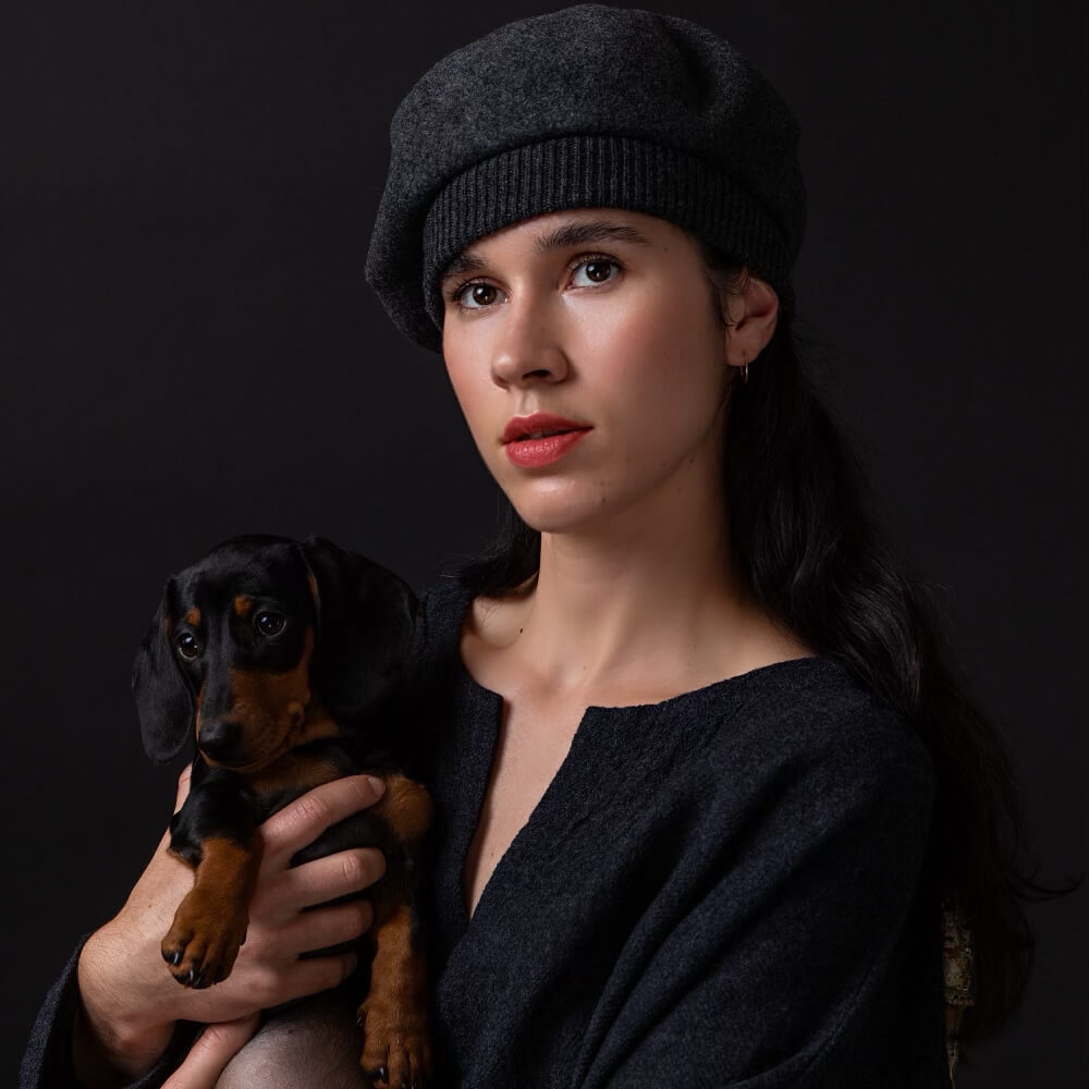 Woman holding a dachshund at Manteau Noir